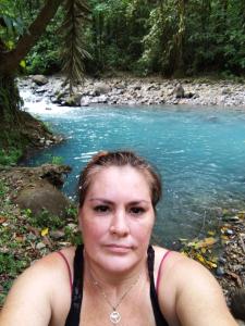a woman standing in front of a river at Maricel house in San Rafael