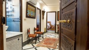 a hallway with a door and chairs in a room at Dar Bouzoubaa in Fez