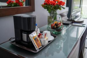 a coffee maker sitting on a counter with a plate of food at Casa de las Flores Hotel in Oaxaca City