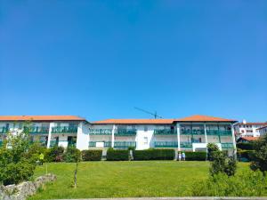 an apartment building with a lawn in front of it at Hendaya vistas increíbles parking in Hendaye