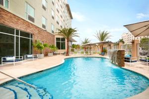 a swimming pool in front of a building at Four Points by Sheraton Miami Airport in Miami