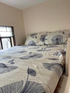 ein Schlafzimmer mit einem Bett mit einer Decke darauf in der Unterkunft Maria Kulafu Lodging House Pier site- Santa Clara office 2nd Floor 