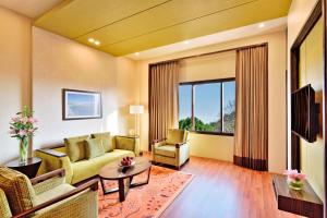 a living room with a couch and a table at Four Points by Sheraton Srinagar in Srinagar