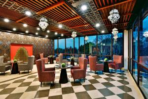 a restaurant with chairs and tables and windows at Four Points by Sheraton Srinagar in Srinagar