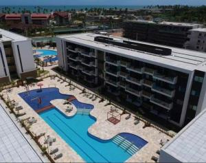 an aerial view of a large building with swimming pools at Flat térreo e condomínio aconchegante ! in Recife +46 photos
