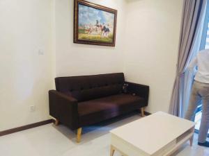a living room with a couch and a picture on the wall at Vinhomes Central Park Apartment Landmark Căn hộ DV in Ho Chi Minh City