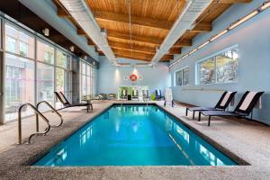 a swimming pool in a house with blue ceilings at Aloft Lexington in Lexington