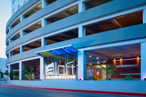 a blue building with a sign on the side of it at Aloft Cancun in Cancún