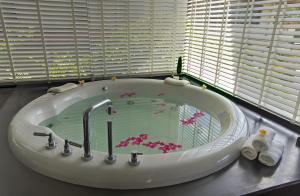 a bath tub with a sink in a bathroom at Luxury Villa in Cape Panwa in Panwa Beach