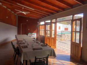 a large dining room with a long table with chairs at La escondida in Salta