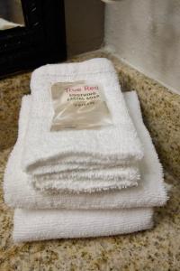 a pile of white towels sitting on a counter at Red Roof Inn Savannah North I-95 - Port Wentworth in Port Wentworth
