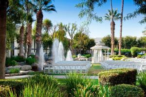 a garden with white chairs and a fountain at Four Points by Sheraton Bakersfield in Bakersfield