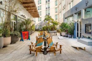a group of chairs and tables in a courtyard at Aloft Jacksonville Tapestry Park in Jacksonville