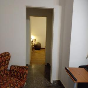 a hallway with a chair and a table at Departamento en Tigre centro in Tigre