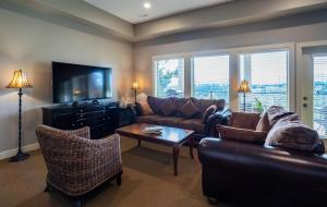 a living room with a couch and a tv at Sunrise Valley Suite in West Kelowna