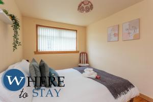 a bedroom with a bed with the words winter to stay at Lovely apartment by the Hillwood Park-Free Parking in Edinburgh