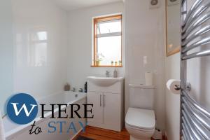 a bathroom with a toilet and a sink and a tub at Lovely apartment by the Hillwood Park-Free Parking in Edinburgh