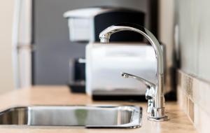 a kitchen counter with a sink next to a kitchen counter at Sunrise Valley Suite in West Kelowna