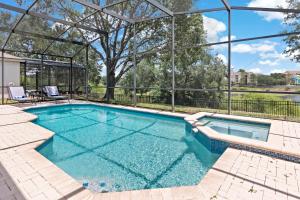 a swimming pool in a house with a large building at The Pink House at Windsor Hills in Orlando