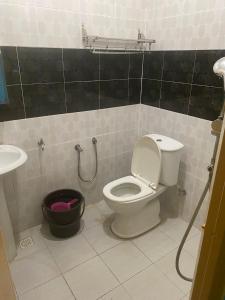 a bathroom with a toilet and a sink at KOTOKOH INN in Machang