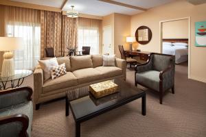 a living room with a couch and a bedroom at Sheraton San Jose in Milpitas