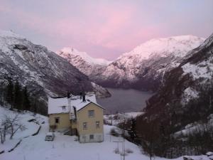 a house in the middle of a snowy mountain at Lunheim in Geiranger in Geiranger