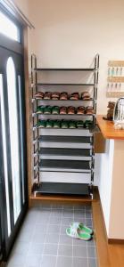 a kitchen with a bunch of donuts on a shelf at HOSTEL198 in Osaka