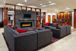 a living room with two couches and a fireplace at Four Points by Sheraton Moncton in Moncton