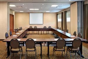 una gran sala de conferencias con una mesa grande y sillas en Four Points by Sheraton Moncton en Moncton