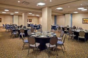 a conference room with tables and chairs in it at Four Points by Sheraton Moncton in Moncton