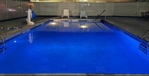 a large pool with blue water in a building at Motel 6 Corbin, KY in Corbin