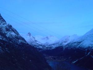 a view of a mountain range with snow covered mountains at Lunheim in Geiranger in Geiranger