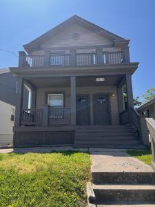 a house with a front porch and stairs in front of it at Rolston 2, Two Bedroom near Xavier Downtown in Bellevue