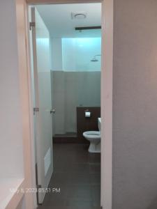 a bathroom with a toilet and a sink at Dumaguete Seafront Hotel in Dumaguete