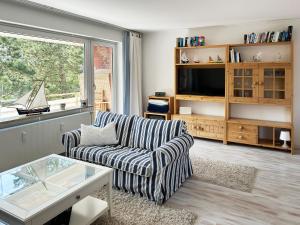 a living room with a couch and a tv at Ferienwohnung Möwenweg 9 Whg 28 in Wittdün