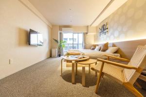 a living room with a couch and a table at Apartment Hotel 11 Namba in Osaka +31 photos