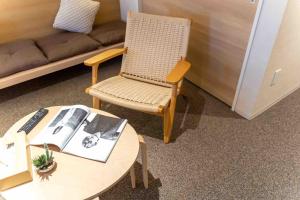 a room with a table and a chair and a couch at Apartment Hotel 11 Namba in Osaka