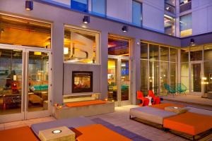 a living room with a fireplace in a building at Aloft Bolingbrook in Bolingbrook