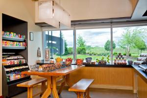 a kitchen with a counter with a large window at Aloft Bolingbrook in Bolingbrook