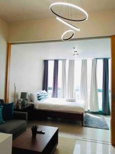 a bedroom with a bed and a large window at One Uptown Residence Prime Loc BGC,Uptown Linked 1BR,Washer,200mbps in Manila