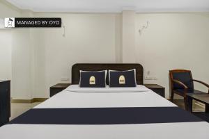 a bedroom with a bed with two pillows on it at Super Townhouse Oak Champapet in Hyderabad
