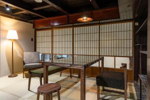 a dining room with a table and chairs at Hotel mio in Shimabara