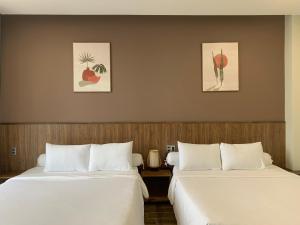 Säng eller sängar i ett rum på Đồi Mây Tuyết Hotel