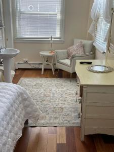 a bedroom with a bed and a living room at Inkwell Beach Cottage in Oak Bluffs