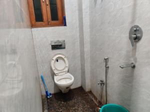 a small bathroom with a toilet in a stall at Hotel EPS in Ghaziabad