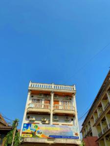 a tall building with a balcony on top of it at Ali Local Home in Vientiane