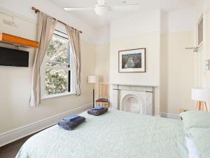 a bedroom with a bed and a fireplace at Lord Wolseley Hotel in Sydney