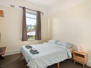 a bedroom with a bed and a window at Lord Wolseley Hotel in Sydney +39 photos