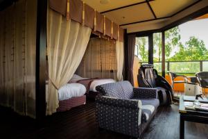 a train room with a bed and a chair at Saiou no Miya in Ise