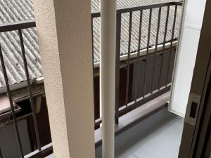 a balcony with black railing and a window at Imazato Ryokan in Osaka